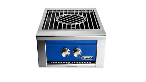 Stono Outdoor Living The Lynx Power Burner in Pacific Blue (LPB-PBNG) is a built-in gas grill with two control knobs, a circular center grill, a high-BTU burner, and the Lynx logo on the front—ideal for any outdoor kitchen.