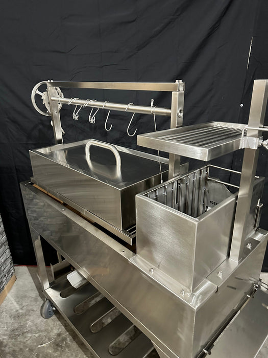 Stono Outdoor Living The Tagwood BBQ Large Top Lid - BBQ59SS by Tagwood BBQ is a stainless steel grill and smoker with a large lid, hooks, shelves, multiple compartments, modern industrial design, main grilling grate, and wheels for easy mobility against a black backdrop.
