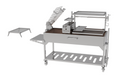 Stono Outdoor Living The Tagwood BBQ Argentine Santa Maria Wood Fire & Charcoal Grill (BBQ26SS) features 304 stainless steel, adjustable racks, a side tray, lower storage shelf, left-side grate, and a raised upper rack that’s partially open for easy access.