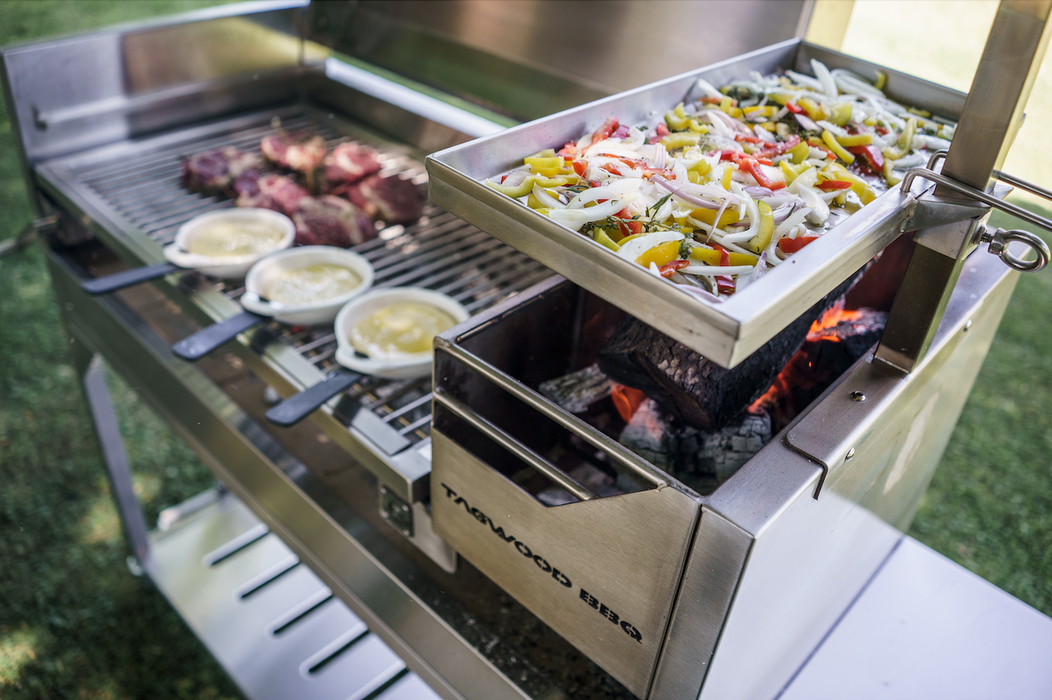Stono Outdoor Living The Tagwood BBQ Height Adjustable Griddle - BBQ54SS lets you grill sliced vegetables on an elevated tray while heating meat and sauces on the main surface, making it a perfect accessory for your Tagwood BBQ grill.