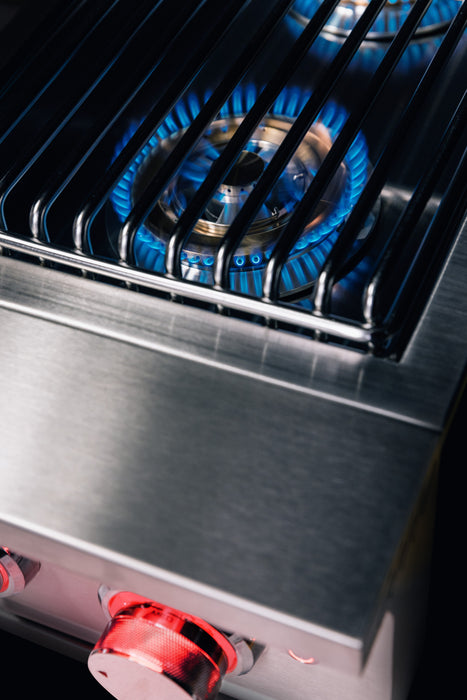 Stono Outdoor Living Close-up of the TrueFlame Double Side Burner - TFSB2 by TrueFlame, featuring stainless steel construction, high-BTU blue flames under metal grates, and red-lit front control knobs—ideal for any outdoor kitchen.