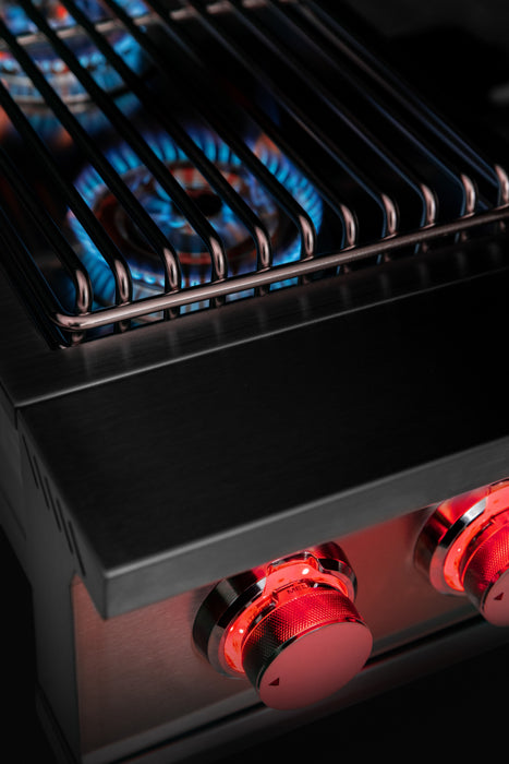 Stono Outdoor Living Close-up of the TrueFlame Gas Double Side Burner - TFSB2L by TrueFlame, featuring stainless steel construction, blue flames under the grill, red-lit control knobs, and side burners—ideal for your outdoor kitchen.