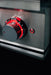 Stono Outdoor Living A close-up of the metallic control knob on the TrueFlame Double Side Burner - TFSB2, illuminated with red LED lights next to a glowing red power button—ideal for any outdoor kitchen by TrueFlame.