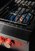 Stono Outdoor Living Close-up of the TrueFlame Propane Gas Power Burner - TFPBL by TrueFlame, featuring high BTU power, two red-lit control knobs, and a blue flame under a sturdy grate—ideal for any outdoor kitchen.