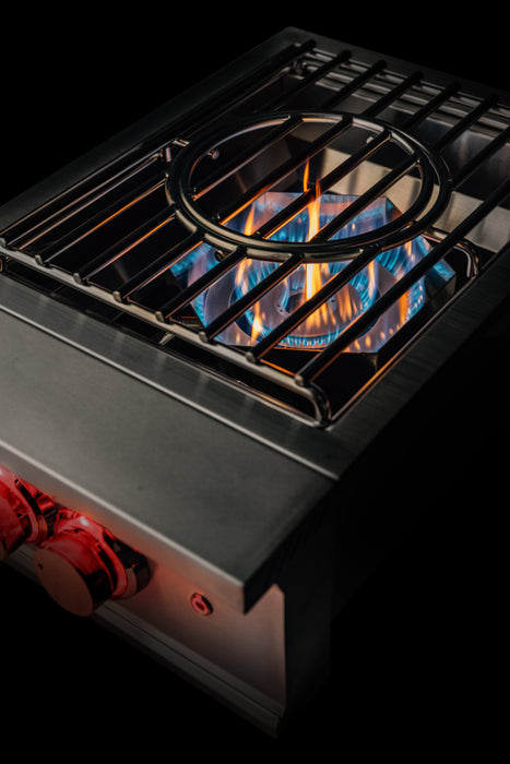 Stono Outdoor Living A close-up of the TrueFlame Natural Gas Power Burner - TFPB by TrueFlame showcases high BTU blue and orange flames, metal grates, and two red control knobs—ideal for outdoor kitchens—all set against a black background.