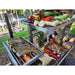 Stono Outdoor Living Colorful vegetables, herbs, and lobster tails are being grilled outdoors on the Tagwood BBQ Argentine Santa Maria Wood Fire & Charcoal Grill - BBQ06SS by Tagwood BBQ near a lakeside dock, surrounded by grass and trees.