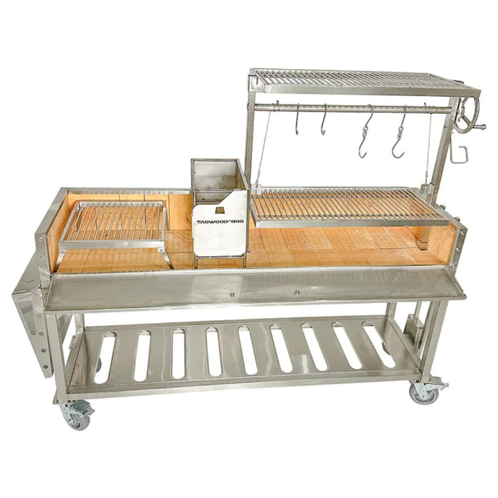 Stono Outdoor Living The Tagwood BBQ Argentine Santa Maria Wood Fire & Charcoal Grill (BBQ06SS) by Tagwood BBQ features 304 stainless steel, multiple grilling racks, food hooks, a wooden workspace, storage shelf, and wheels for easy mobility.