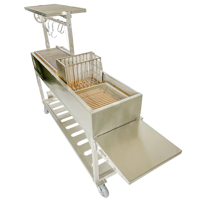 Stono Outdoor Living The Tagwood BBQ Argentine Santa Maria Wood Fire & Charcoal Grill - BBQ06SS by Tagwood BBQ features 304 stainless steel, wheels, a grilling grate, storage rack, food basket, side prep shelf, and utensil hooks—ideal for authentic Argentine or Santa Maria grilling.