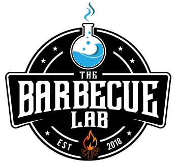 Stono Outdoor Living A circular logo featuring a bubbling flask with blue liquid at the top, The Barbecue Lab in bold letters, stars on each side, and a small flaming fire with EST 2018 at the bottom.