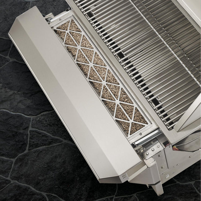 Stono Outdoor Living Close-up of a stainless steel gas grill with a smoke box beside the Twin Eagles Wi-Fi Controlled 36-Inch Built-In Pellet Grill and Smoker (TEPG36G) on a dark stone patio with premium outdoor cooking equipment.