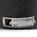 Stono Outdoor Living Close-up of the stainless steel vent on the Coyote Asado Smoker, Built-In - C1CHCS by Coyote, shown on a textured black surface. This feature allows for precise temperature control during outdoor cooking.