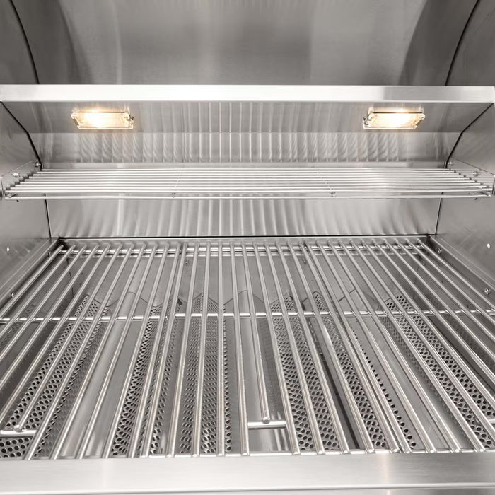 Stono Outdoor Living Close-up view of the Coyote 34" C-Series Grill (C3C34NG) in natural gas, featuring a clean stainless steel interior, two wire racks, built-in lighting, and a shiny finish—ideal for any outdoor kitchen.