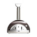 Stono Outdoor Living The Coyote 40" Duomo Wood Fired Outdoor Oven, Copper (C1PZ40WC) features a stainless steel build, tall chimney, curved dark exterior, ceramic dome, temperature gauge, and dual front handles—shown against a plain white background.