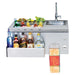 Stono Outdoor Living The Twin Eagles 30-Inch Built-In Stainless Steel Outdoor Bar With Sink and Ice Bin Cooler (TEOB30-B) offers a faucet, insulated ice bin for beverages, fresh garnishes, assorted liquors, and a towel rack—perfect for stylish outdoor entertaining.
