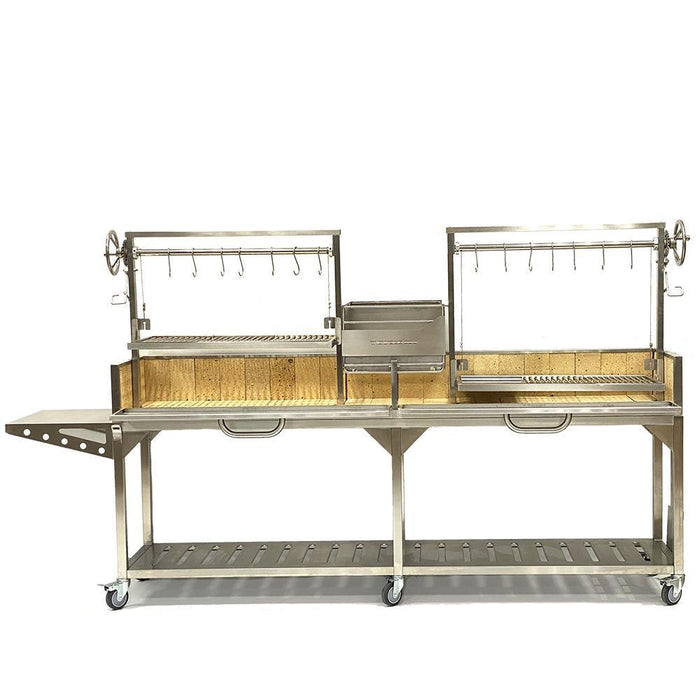 Stono Outdoor Living The Tagwood BBQ Double Argentine Santa Maria Wood Fire & Charcoal Grill (BBQ04SS) features two adjustable racks, meat hooks, side shelf, lower storage rack, and wheels for easy outdoor open fire grilling—crafted in stainless steel by Tagwood BBQ.