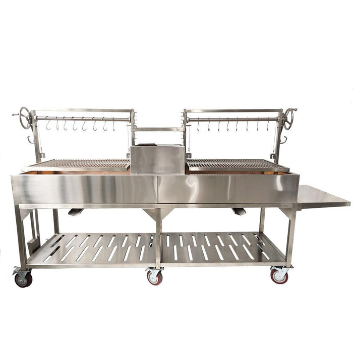 Stono Outdoor Living The Tagwood BBQ XL Double Argentine Santa Maria Wood Fire & Charcoal Grill (BBQ24SS) by Tagwood BBQ features 304 stainless steel, dual sections, adjustable grates, hanging hooks, a side shelf, and wheels—ideal for open fire grilling and barbecue catering.