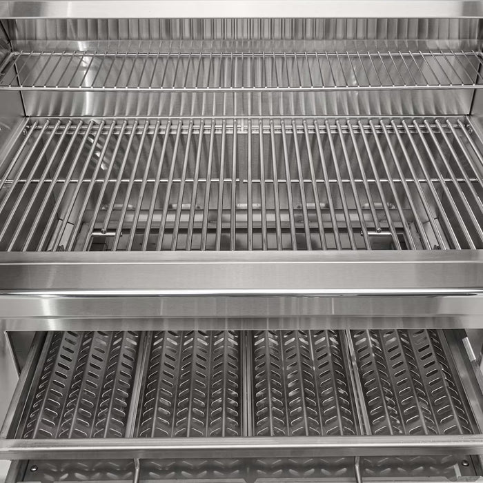 Stono Outdoor Living Close-up of the Coyote 36" Charcoal Grill (C3CH36), a stainless steel built-in model with three adjustable cooking racks and a V-shaped drip tray on the bottom rack—ideal for outdoor grilling.