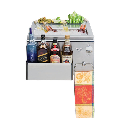 Stono Outdoor Living The Twin Eagles 18-Inch Built-In Stainless Steel Outdoor Bar (TEOB18-B) holds liquor bottles, four chilled wine bottles in an insulated compartment, garnishes like olives and limes, and features a side rack for a colorful towel.