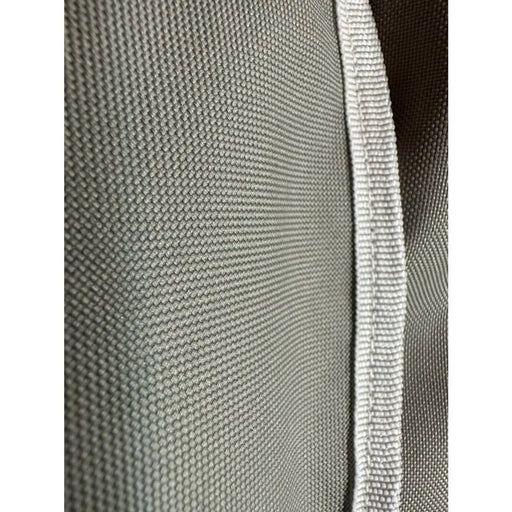 Stono Outdoor Living Close-up of the Coyote Cover for CDSB Dual Burner, Gray (CCVRDB-BIG) by Coyote, featuring gray ballistic nylon fabric with a white trim and woven texture typical of weather-resistant appliance covers.