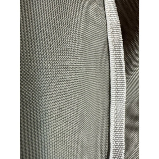 Stono Outdoor Living Close-up of the durable gray fabric with a white woven edge featured on the Coyote Cover for Electric Grill (CCVREL-BIG) by Coyote, showcasing its textured weave designed for weather-resistant outdoor protection.