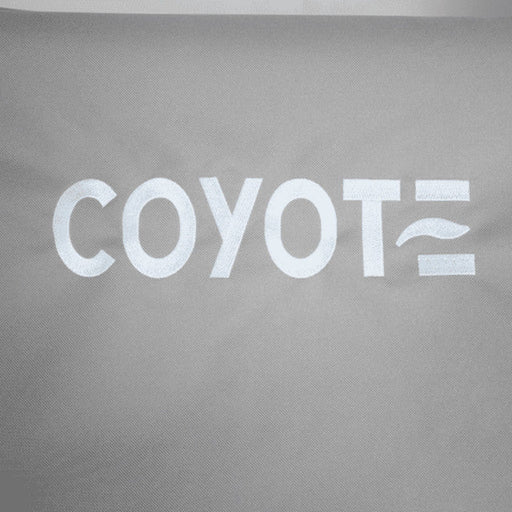 Stono Outdoor Living White text on a gray fabric background reads "COYOTE," with the final E as three lines—the middle wavy—reflecting the durability and style of the Coyote Cover for Electric Grill - CCVREL-BIG, designed to protect your outdoor grill.