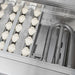 Stono Outdoor Living Close-up view of the Delta Heat 26-Inch 2-Burner Built-In Natural Gas Grill (model DHBQ26G-DN), featuring ceramic briquettes on the left and metal gas burner tubes on the right—a must-have for outdoor kitchens.