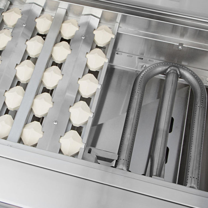 Stono Outdoor Living Close-up of the Delta Heat 38-Inch 3-Burner Built-In Propane Gas Grill (DHBQ38G-DL) interior, featuring ceramic briquettes on the left and metal burner tubes on the right—a premium addition to any outdoor kitchen.