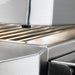 Stono Outdoor Living Close-up of a stainless steel panini press with ridged plates and an alignment pin, featuring clean, reflective surfaces that mirror the premium quality of the Twin Eagles 30-Inch 2-Burner Built-In Gas Grill with Sear Zone & Rotisserie.