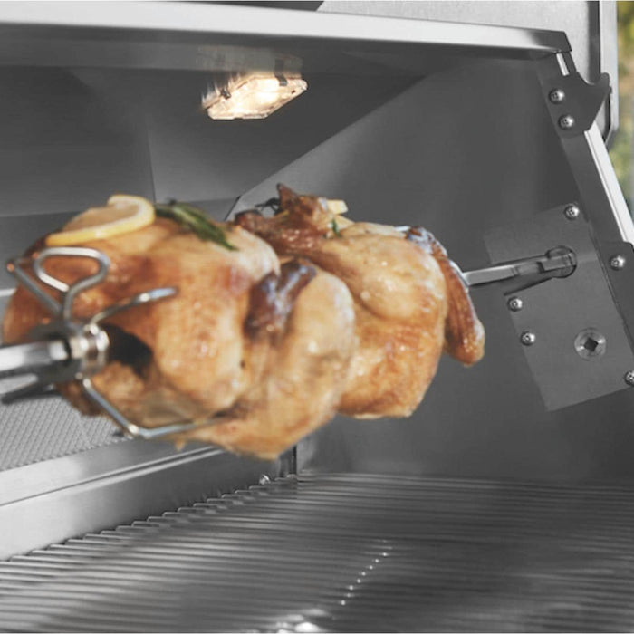 Stono Outdoor Living A whole chicken roasts on a rotisserie spit inside the Twin Eagles 30-Inch 2-Burner Built-In Gas Grill (TEBQ30R-CL), with its stainless steel burners and warm interior lighting highlighting the premium design.