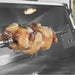 Stono Outdoor Living A close-up of a rotisserie chicken roasting on a spit inside the Twin Eagles 42-Inch 3-Burner Built-In Gas Grill (TEBQ42RS-CN), with the Five-Part Grilling System and interior lights illuminating the chicken and sleek stainless steel.