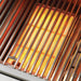 Stono Outdoor Living Close-up of the Delta Heat 32-Inch 3-Burner Built-In Natural Gas Grill (DHBQ32RS-DN) with bright orange heating elements glowing beneath the grates, showing the sear zone is activated and preheating for cooking.