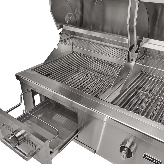 Stono Outdoor Living A close-up of the Coyote 50" Hybrid Grill, Built-In Natural Gas (C3HY50NG) shows its clean stainless steel grates and pull-out drip tray. This versatile Coyote grill runs on natural gas or charcoal, and the cooking area is empty and gleaming.