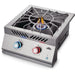 Stono Outdoor Living The Napoleon Built-In 700 Series Propane Gas Power Burner (BIB18PBPSS) features a stainless steel cover, blue and orange flames, two control knobs (blue and red), a sturdy metal grate, and the Napoleon logo on the front panel.